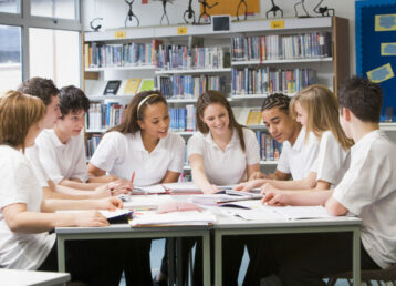 Teen Pupils Studying In School Library